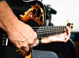 Miguel playing Adamas Ovation guitar