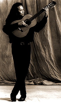 Miguel playing guitar standing up